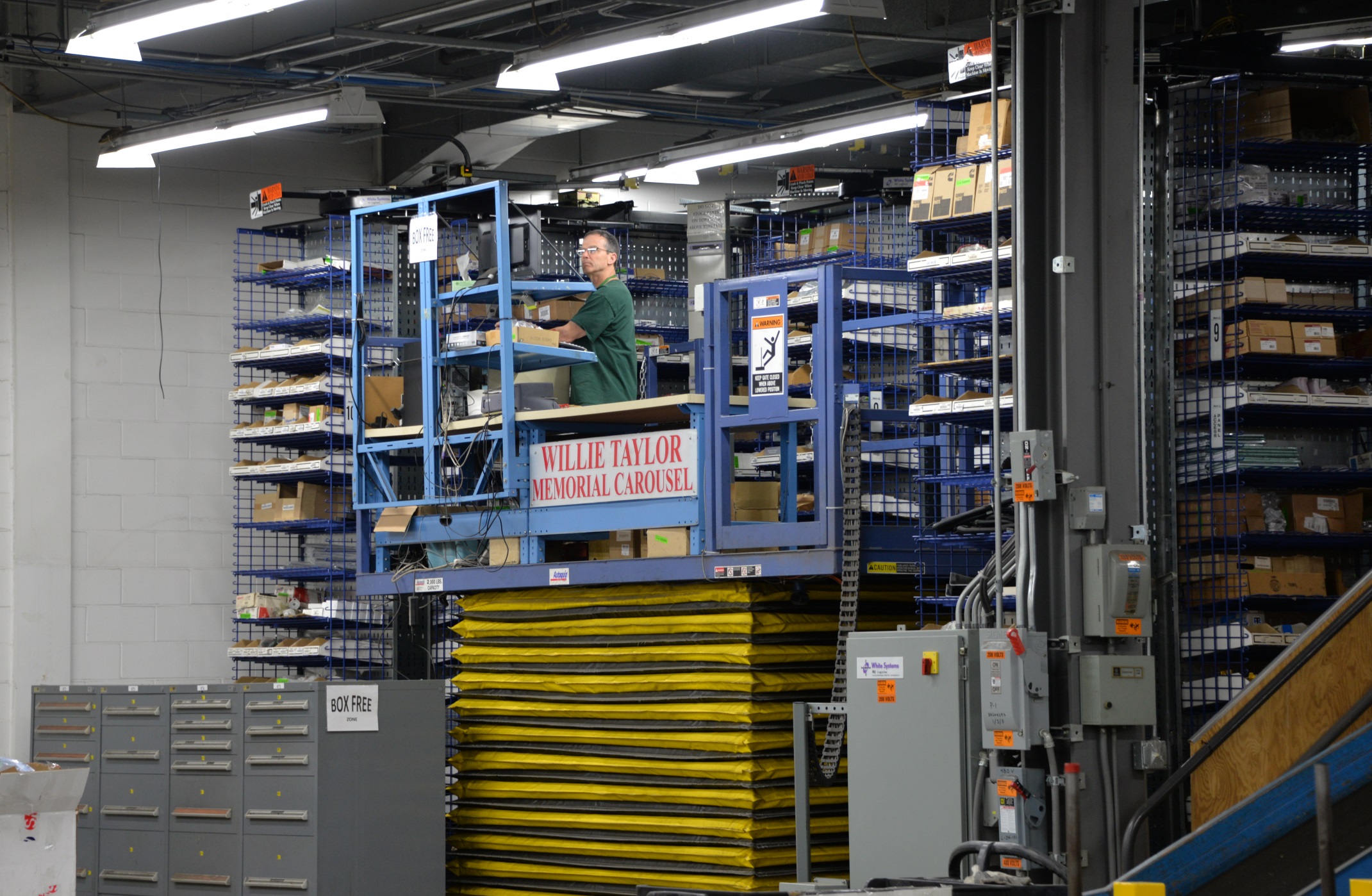 A mechanical lift at Metro Transit's Overhaul Base helps stockkeepers to reach items stored on vertical shelves. 