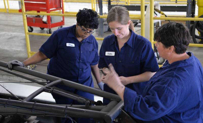 Participants in the Metro Transit Technician program work on a pantograph at the Hiawatha Operations & Maintenance Facility.