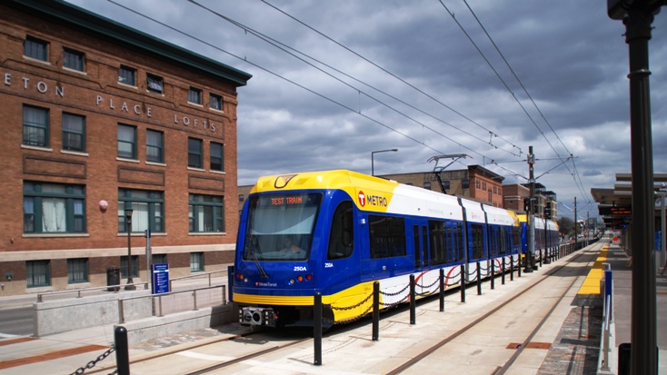 A METRO Green Line train pulls into the Raymond Avenue Station.