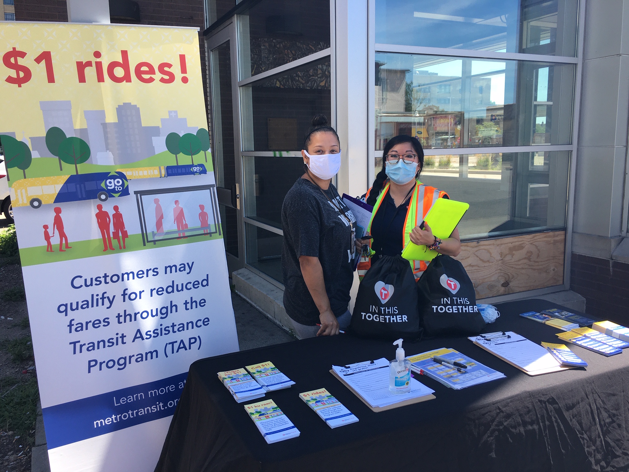 Photo of two outreach staff at a table with information about Metro Transit programs.