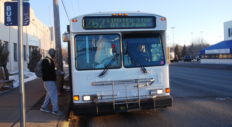 Customers board a Route 262 bus on Rice Street in St. Paul.