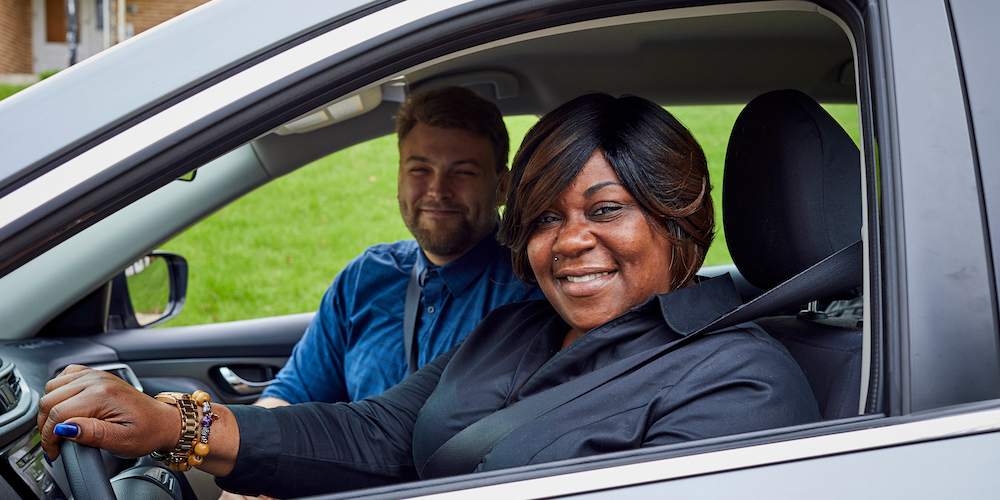 two people riding in a car together